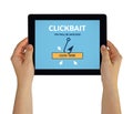 Hands holding tablet with clickbait concept on screen