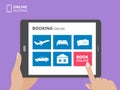 Hands holding tablet computer and touching screen with book button on screen. Design concept for online booking Royalty Free Stock Photo