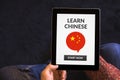 Hands holding tablet with learn Chinese concept on screen Royalty Free Stock Photo