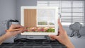 Hands holding tablet showing modern bedroom close-up. Unfinished sketch draft of child bedroom with single bed in the background,