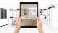 Hands holding tablet showing modern white and wooden kitchen. Blueprint CAD sketch background, augmented reality concept,