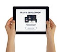 Hands holding tablet with UI/UX design and development concept on screen Royalty Free Stock Photo