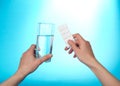 The hands holding tablets and glass with water Royalty Free Stock Photo