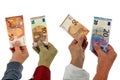 Crowdfunding concept with hands holding banknotes of European currency close-up on white background