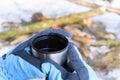 Hands holding thermos cup of tea isolated outdoors. Outdoor winter concept Royalty Free Stock Photo
