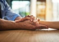 Hands holding together with love, support and care in a touching and bonding moment. Closeup of a close, loving hand