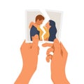 Hands holding a torn photo of a couple in love Royalty Free Stock Photo
