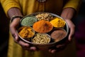 Hands holding a traditional Indian spice box (Masala Dabba) with curcuma as a centerpiece. Generative AI Royalty Free Stock Photo