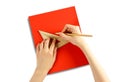 Hands holding a triangular ruler and pencil on a red paper. Closeup Royalty Free Stock Photo