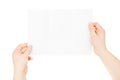 Hands holding trifold empty brochure, slightly folded, isolated