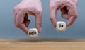 Hands are holding two cubes with the German words `ja` and `nein`