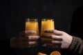 Hands holding two glasses of orange juice generative AI Royalty Free Stock Photo
