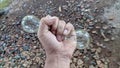 Hands holding two light bulbs on the ground Royalty Free Stock Photo