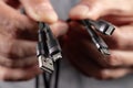 hands holding universal adapter cable from USB connector to micro USB, mini-USB and other connectors Royalty Free Stock Photo