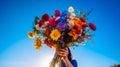 Hands holding a vibrant bouquet of wildflowers on a bright blue sky background. Generative AI Royalty Free Stock Photo