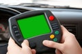 Hands holding vintage game console controller with green screen in car interior Royalty Free Stock Photo