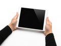 Hands holding a white tablet with a black screen against a white background Royalty Free Stock Photo