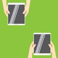 Hands holding white tablet computers on a green background. Vector illustration in flat design. Royalty Free Stock Photo