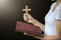 Hands holding wooden cross over open russian holy bible on on sunrise background, Crucifix, Symbol of Faith Royalty Free Stock Photo