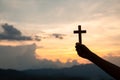 Hands holding wooden cross on sky background, Crucifix, Symbol of Faith