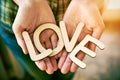 Hands holding wooden letters with word love Royalty Free Stock Photo