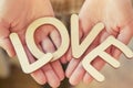 Hands holding wooden letters with word love Royalty Free Stock Photo