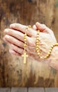 Hands holding wooden rosary Royalty Free Stock Photo