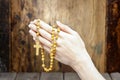 Hands holding wooden rosary Royalty Free Stock Photo