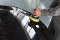 Close-up of hands worker using polisher to polish a gray car body in the workshop, Auto Mechanic Polishing Car Royalty Free Stock Photo