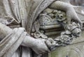 Hands holding the wreath. Old cemetery sculpture. Royalty Free Stock Photo