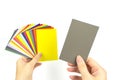 Hands holds acolor palette of paints on a white background. Color card paint samples Royalty Free Stock Photo