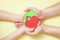 Hands holds green paper house with red heart Royalty Free Stock Photo