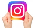 Hands holds Instagram icon on white background Royalty Free Stock Photo