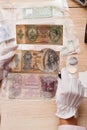 Hands holds a set of old bills in the pockets