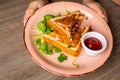 Hands of human hold plate of fresh appetizing toasts with savory tomato sauce on table background closeup. Serving of