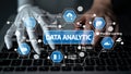 Hands of a Human and a Robot Collaborating on Data Analytics Tasks with Graphical Icons Displayed on a Keyboard in a Royalty Free Stock Photo