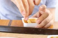 Hands of a hungry boy dipping in sauce and eating a fried potatoes on the summer terrace of the city fast food restaurant, close Royalty Free Stock Photo