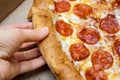 Hands of hungry people taking hot delicious italian pepperoni pizza, home delivery concept Royalty Free Stock Photo