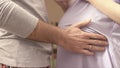 Hands of husband on the tummy of his pregnant wife. husband tenderly stroked pregnant belly of his wife. Young man Royalty Free Stock Photo