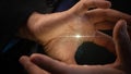 In the hands illuminated inside, a digital microchip with a human brain appears