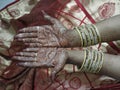 Hands of an indian bride decorated with mehandi and bangles Royalty Free Stock Photo
