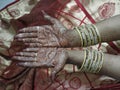 Hands of an indian bride decorated with mehandi and bangles