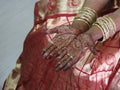 Hands of an indian bride decorated with mehandi and bangles