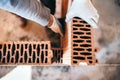 hands of industrial male bricklayer installing bricks on construction site Royalty Free Stock Photo