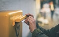 Hands inserting envelope in mail box Royalty Free Stock Photo