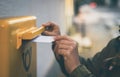 Hands inserting envelope in mail box Royalty Free Stock Photo