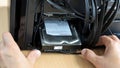 Hands inserts hard disk memory into system unit of computer Royalty Free Stock Photo
