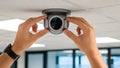 Hands Installing Modern Security Camera on Ceiling Royalty Free Stock Photo