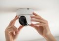 Hands installing white security camera installation Royalty Free Stock Photo