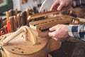 Hands of an instrument maker working on a Hurdy Gurdy